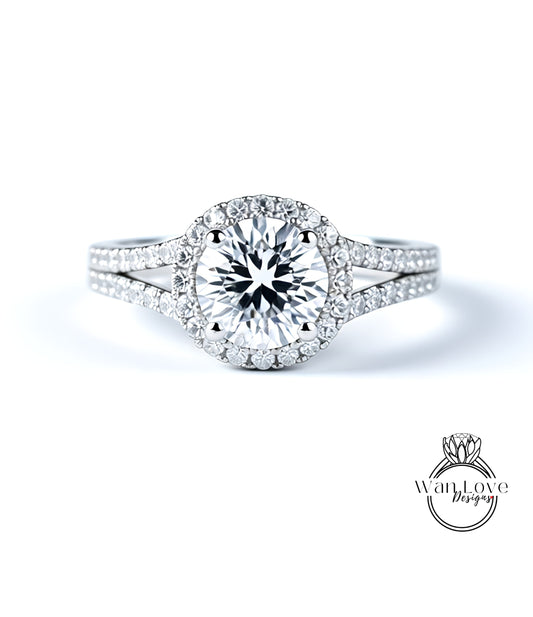 A stunning diamond engagement ring with a large central diamond surrounded by smaller diamonds set in a halo of smaller diamonds.