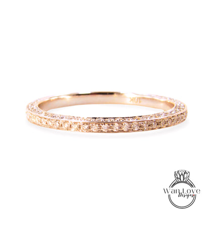 A gold ring with a row of small diamonds along the band.