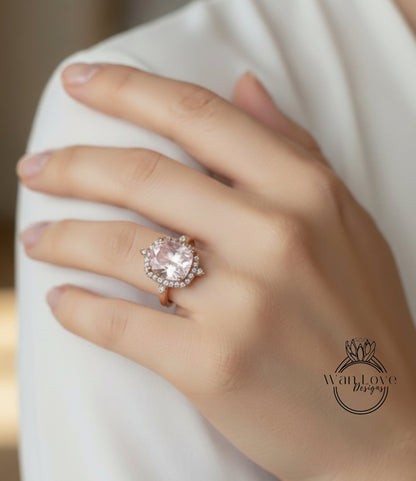 A close-up of a person's hand wearing a large, ornate ring with a large, pink gemstone.