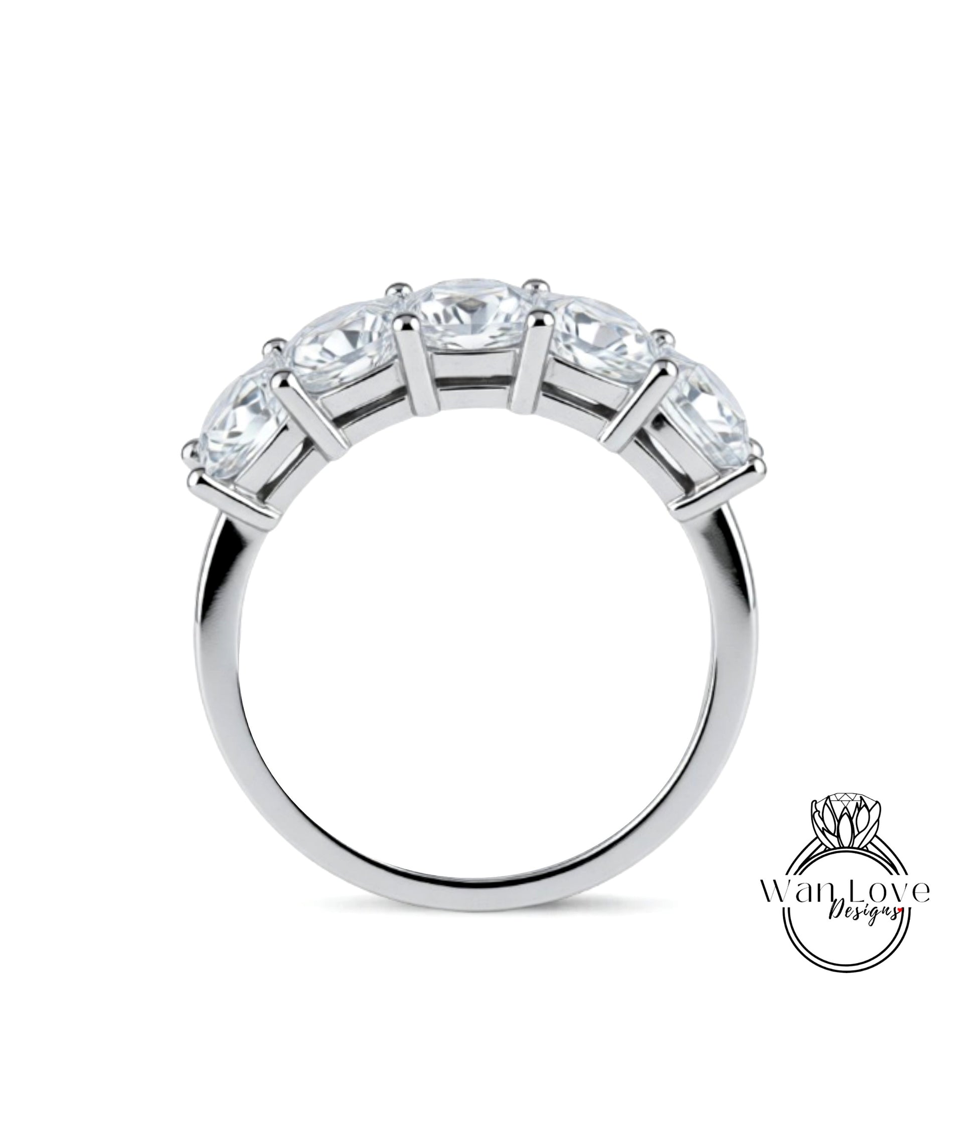 A silver ring with a row of five clear gemstones set in the band.