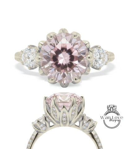 A beautiful pink gemstone engagement ring with a large central gemstone surrounded by smaller stones and a delicate floral design.