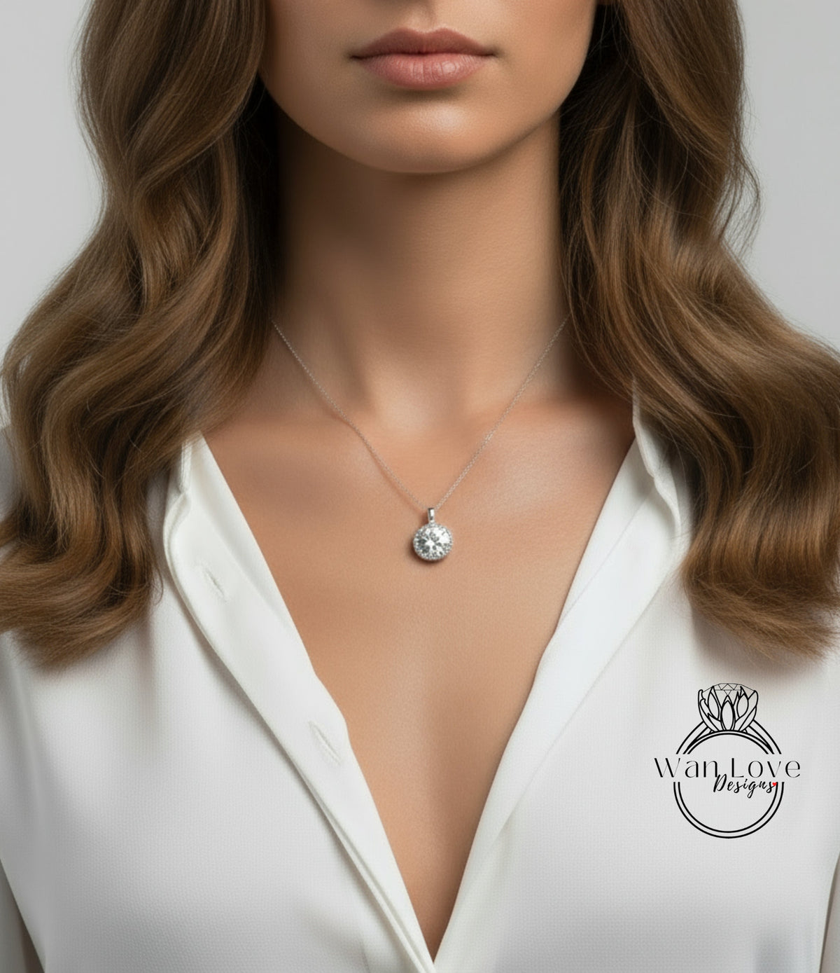 A close-up of a woman's neck and chest wearing a necklace with a pendant.