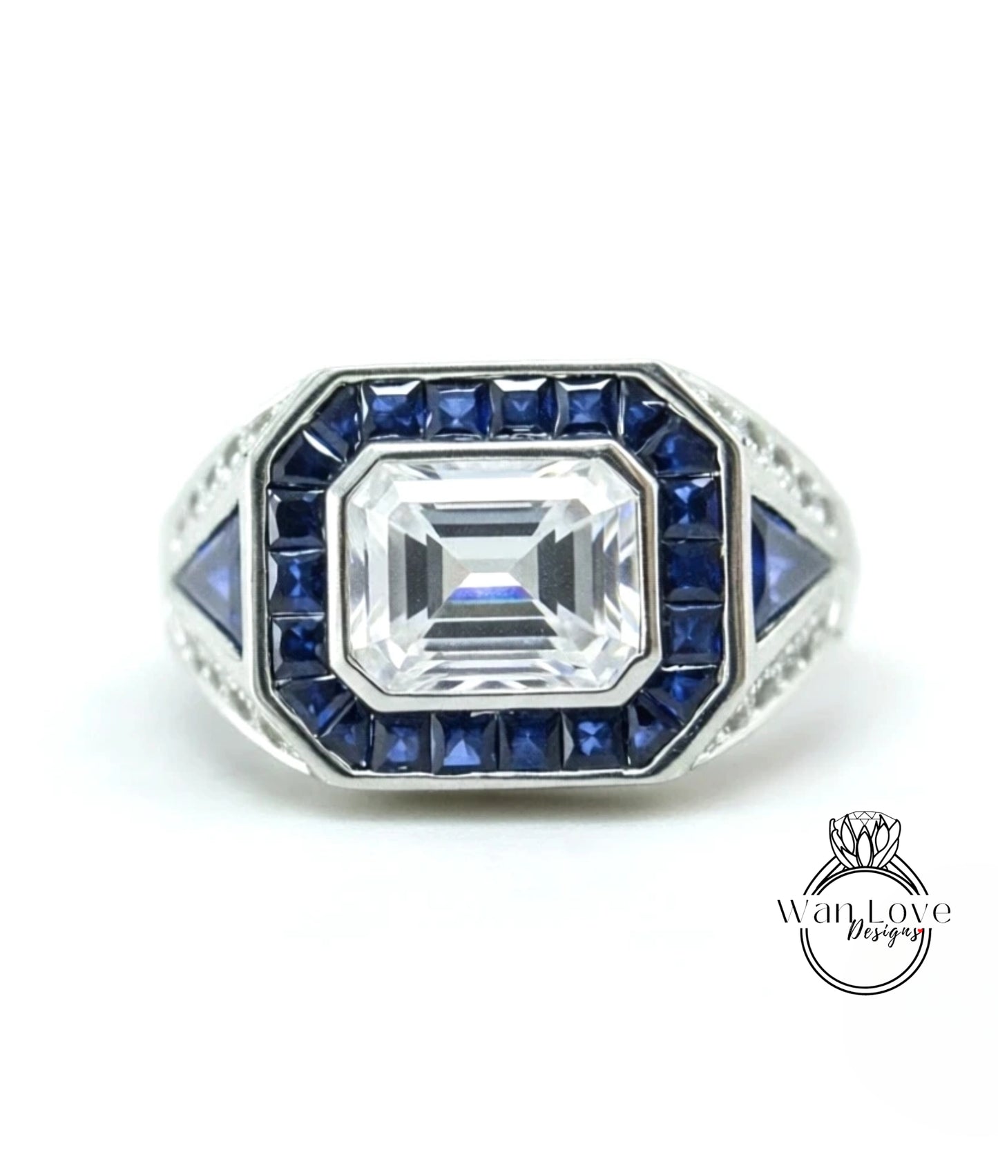 A silver ring with a large central gemstone surrounded by smaller blue gemstones.