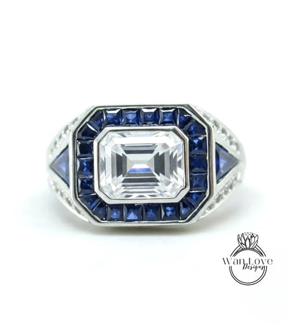 A silver ring with a large central gemstone surrounded by smaller blue gemstones.