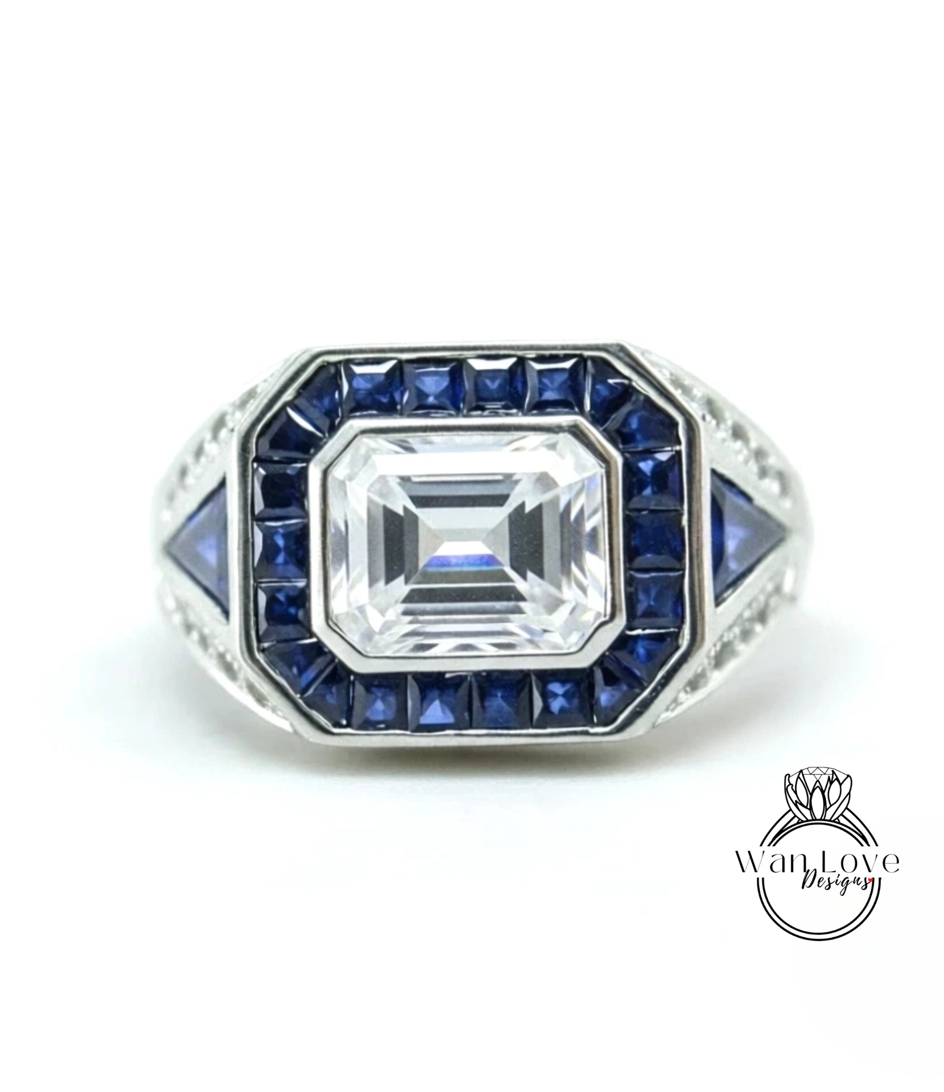 A silver ring with a large central gemstone surrounded by smaller blue gemstones.