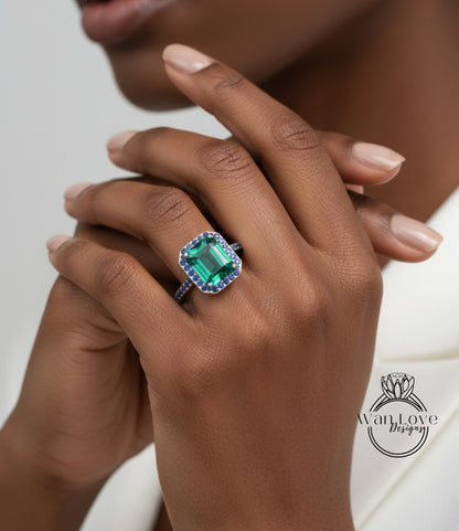 A close-up of a person's hand wearing a large, green gemstone ring with blue accents.