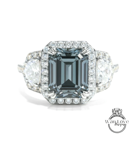 A stunning engagement ring featuring a large, dark blue diamond surrounded by smaller diamonds and set in a halo of smaller diamonds.