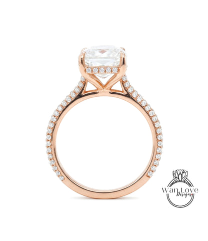 A close-up of a rose gold engagement ring with a large, clear gemstone set in the center.