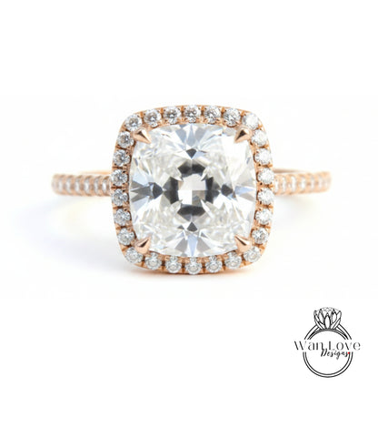 A large, clear diamond engagement ring with a halo of smaller diamonds around the center stone.