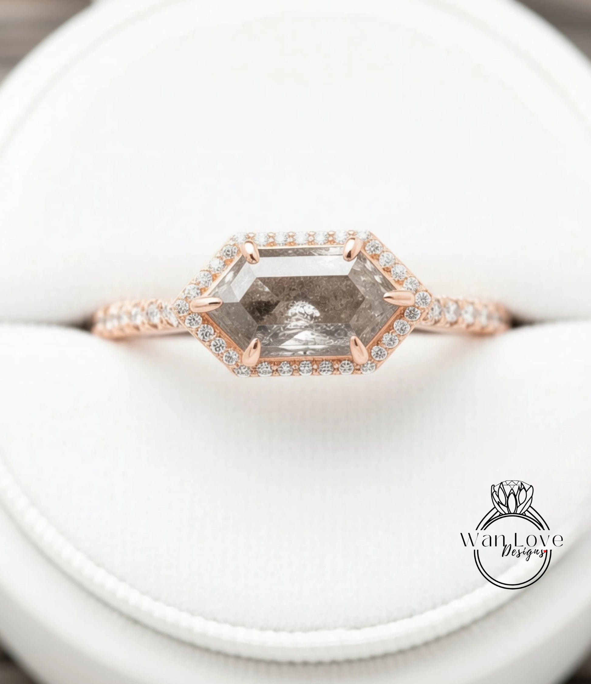 A close-up image of a diamond engagement ring with a large, clear gemstone set in a rose gold band.