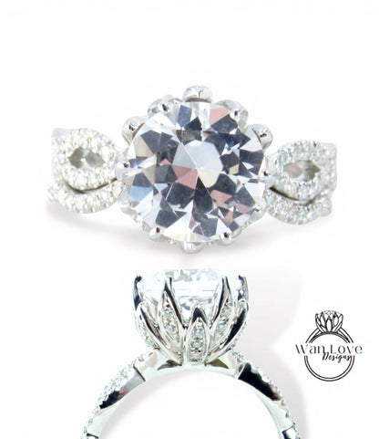 A close-up view of a diamond engagement ring with a large, round brilliant-cut diamond set in a silver band with smaller diamonds.