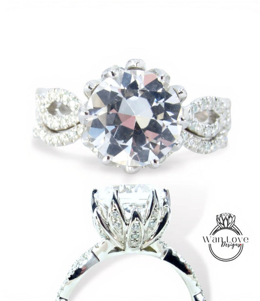 A close-up view of a diamond engagement ring with a large, round brilliant-cut diamond set in a silver band with smaller diamonds.