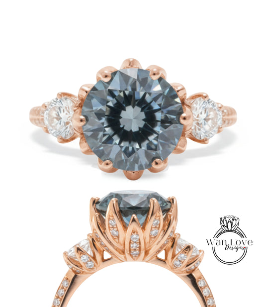 a beautiful engagement ring with a large blue gemstone set in a rose gold band. The ring is adorned with smaller diamonds and has a delicate floral design around the gemstone.