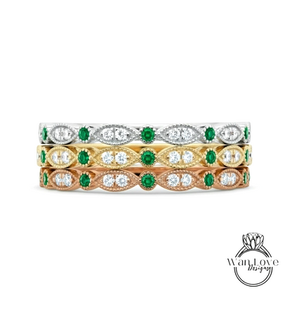 A stack of three rings with green and white gemstones set in gold and silver tones.