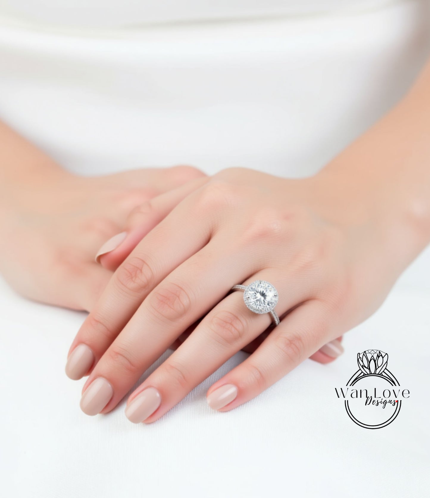 A close-up of a person's hands wearing a large, sparkling diamond engagement ring.
