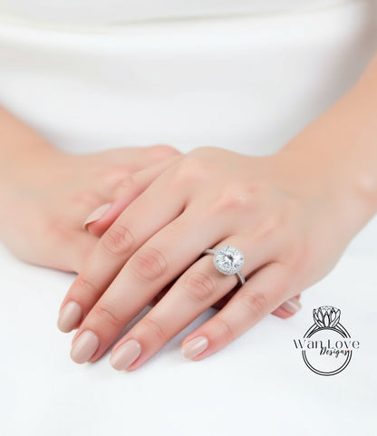 A close-up of a person's hands wearing a large, sparkling diamond engagement ring.