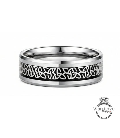 A silver ring with a black Celtic knot design on the band.