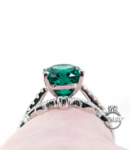 A close-up view of a silver ring with a large, vibrant green gemstone, showcasing the intricate design and craftsmanship of the piece.