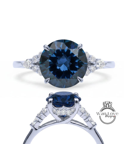 A stunning blue diamond engagement ring with a large central diamond surrounded by smaller diamonds on either side. The ring is set in a silver band, and the image showcases the intricate design and craftsmanship of the piece.