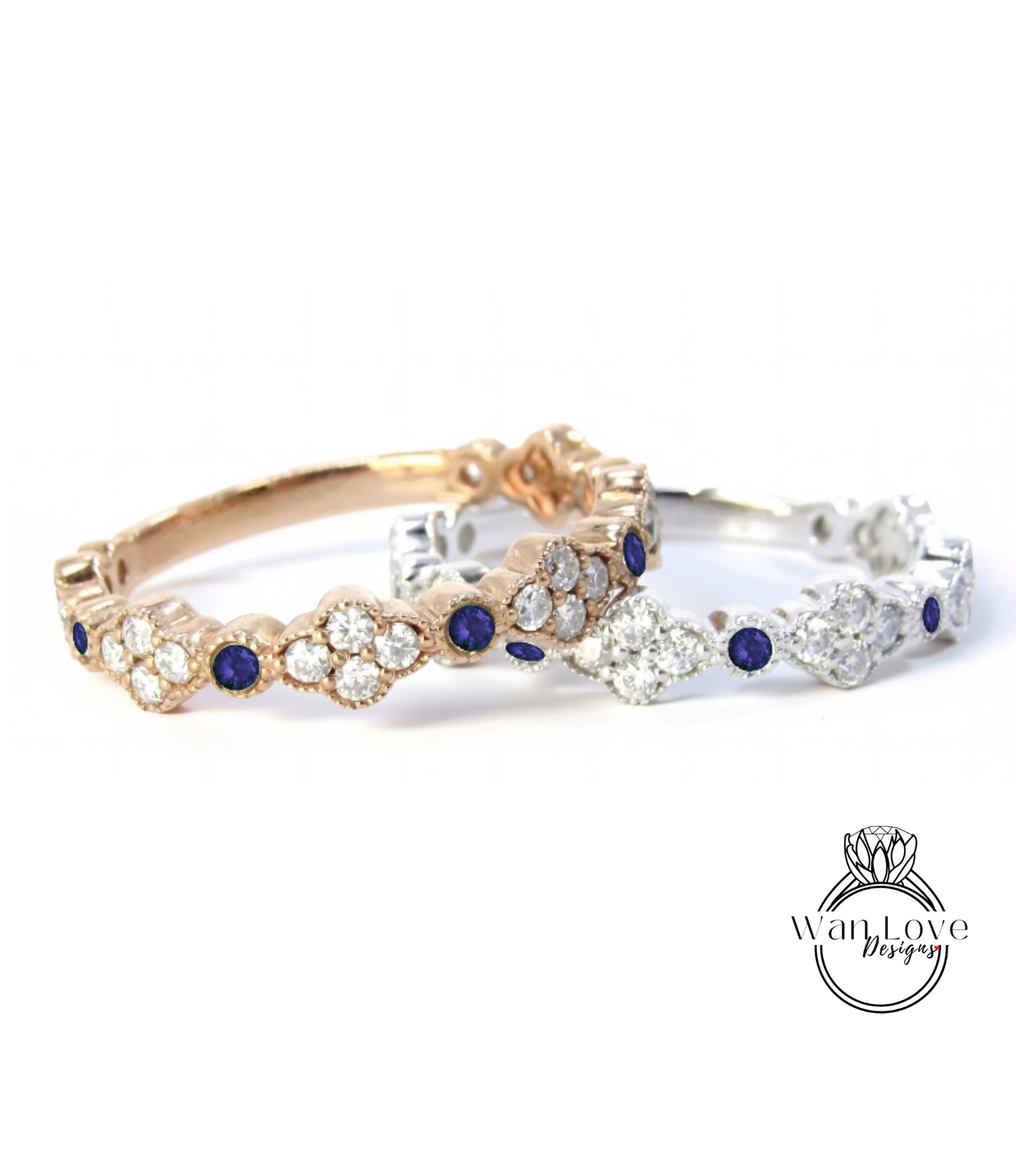 two rings with blue gemstones, one in gold and one in silver, placed side by side against a white background.