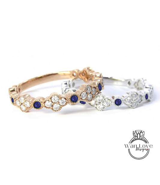 two rings with blue gemstones, one in gold and one in silver, placed side by side against a white background.
