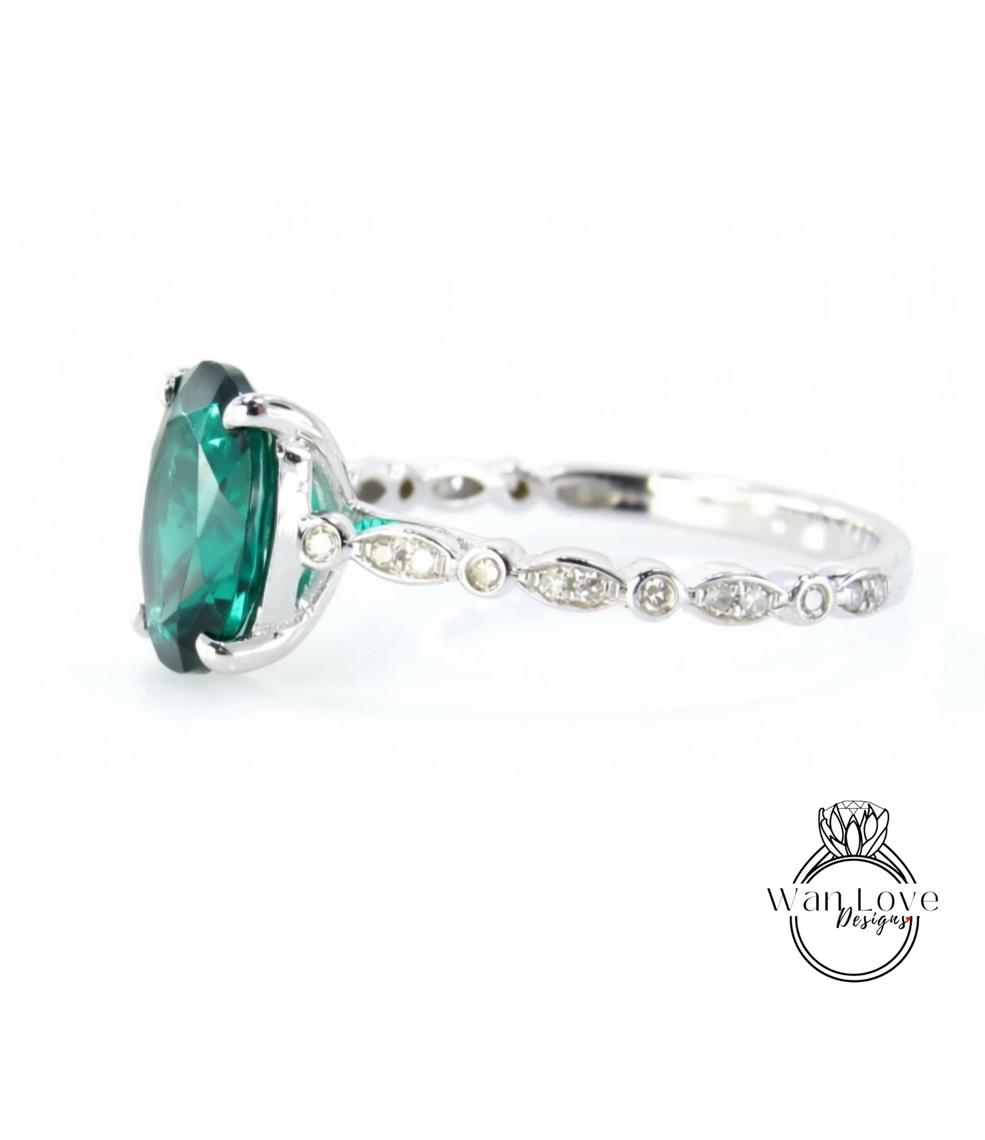 A close-up view of a silver ring with a large, vibrant green gemstone, possibly a diamond, set in the center.