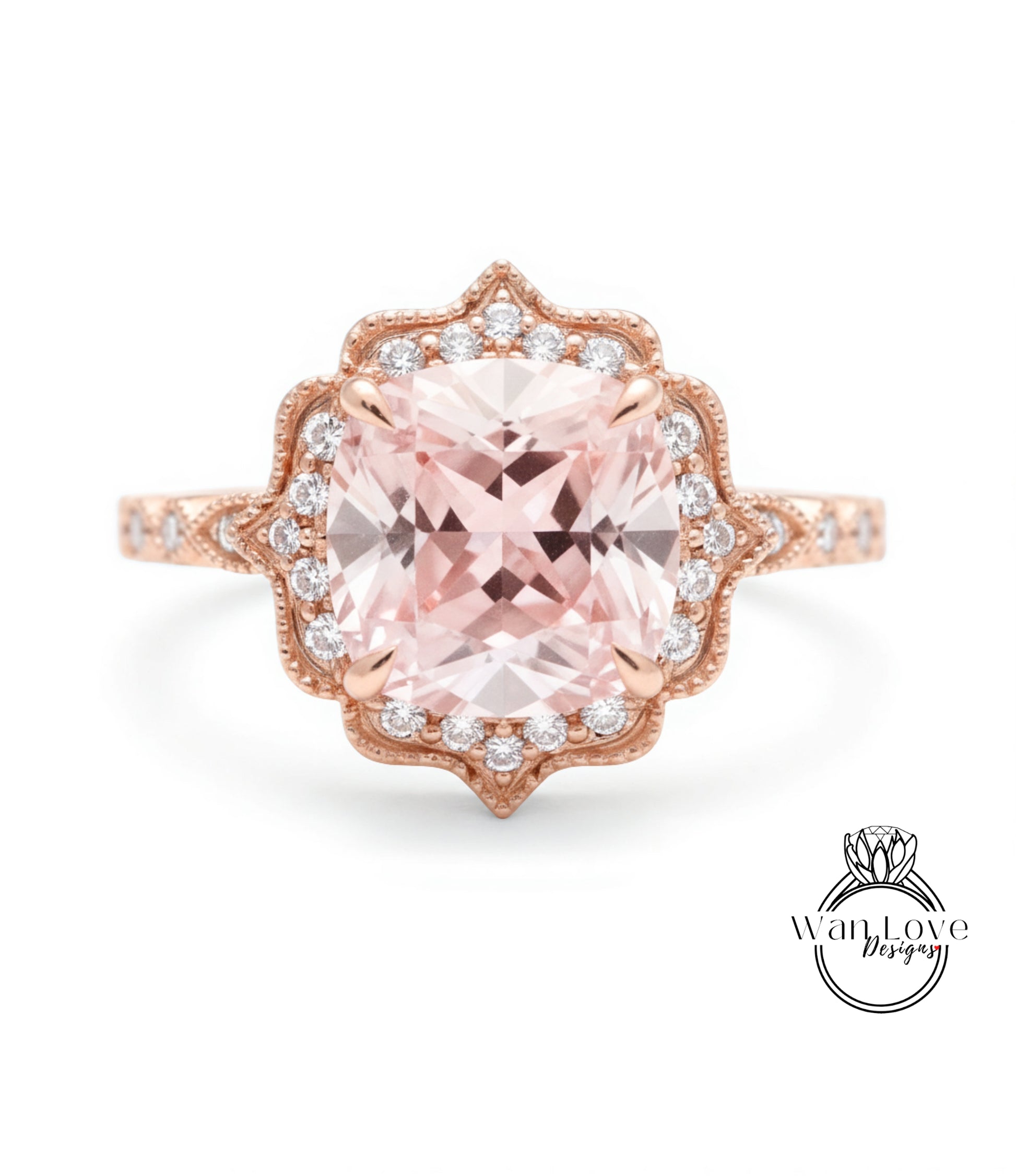 A beautiful pink gemstone ring with a large central gemstone surrounded by smaller diamonds set in an ornate, scalloped design.