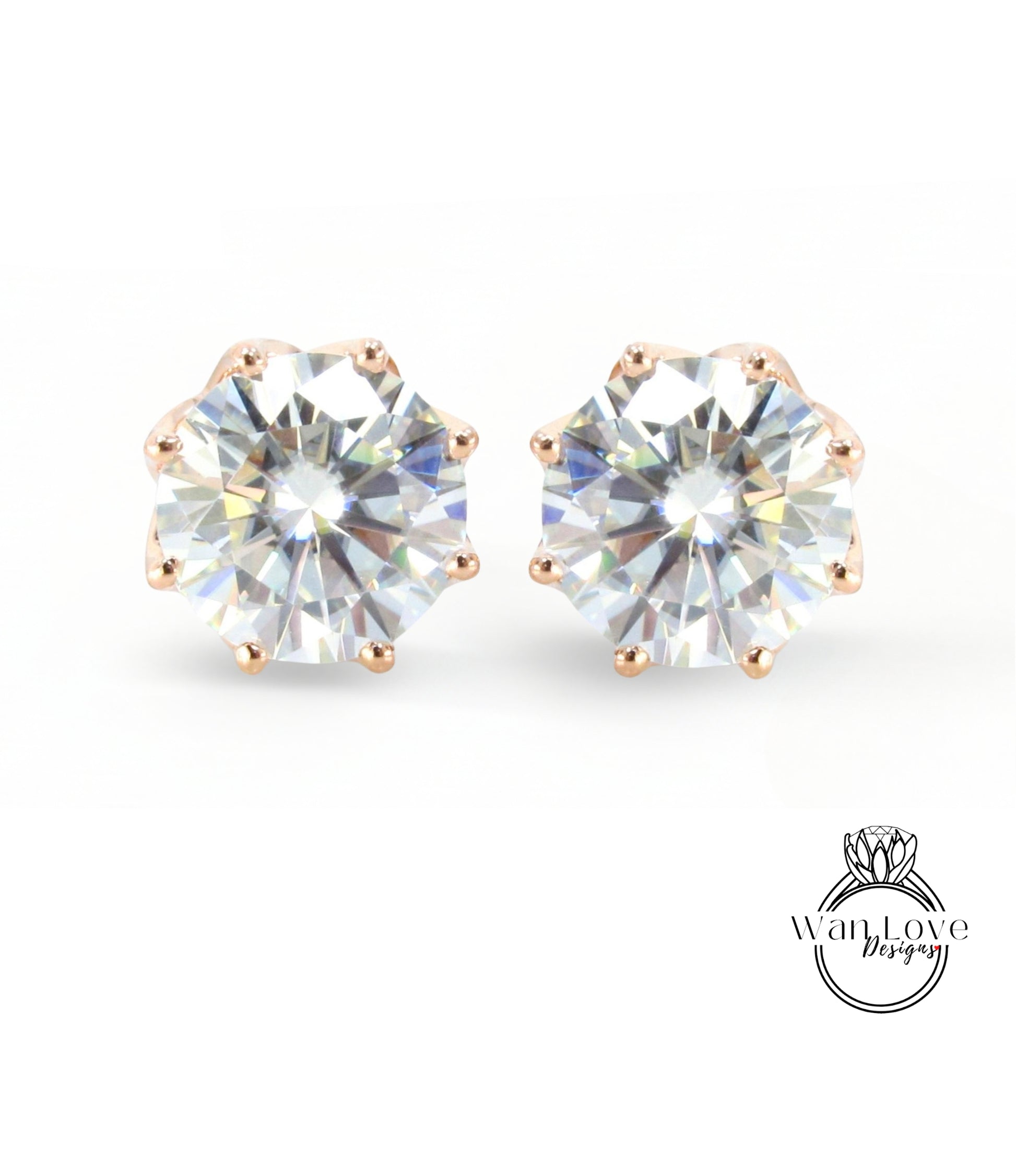 A pair of elegant earrings with large, clear gemstones set in a gold-colored metal.