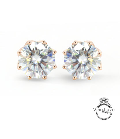A pair of elegant earrings with large, clear gemstones set in a gold-colored metal.