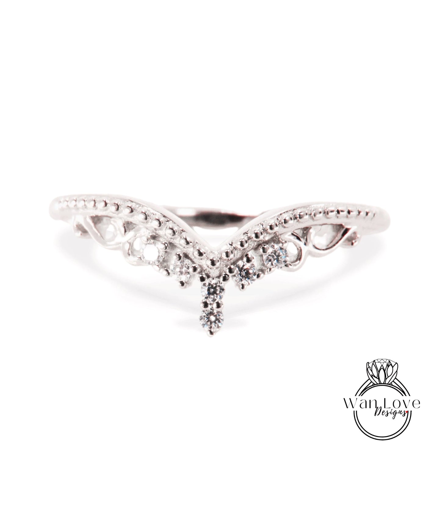 A silver ring with a decorative design featuring a central diamond and smaller diamonds surrounding it.