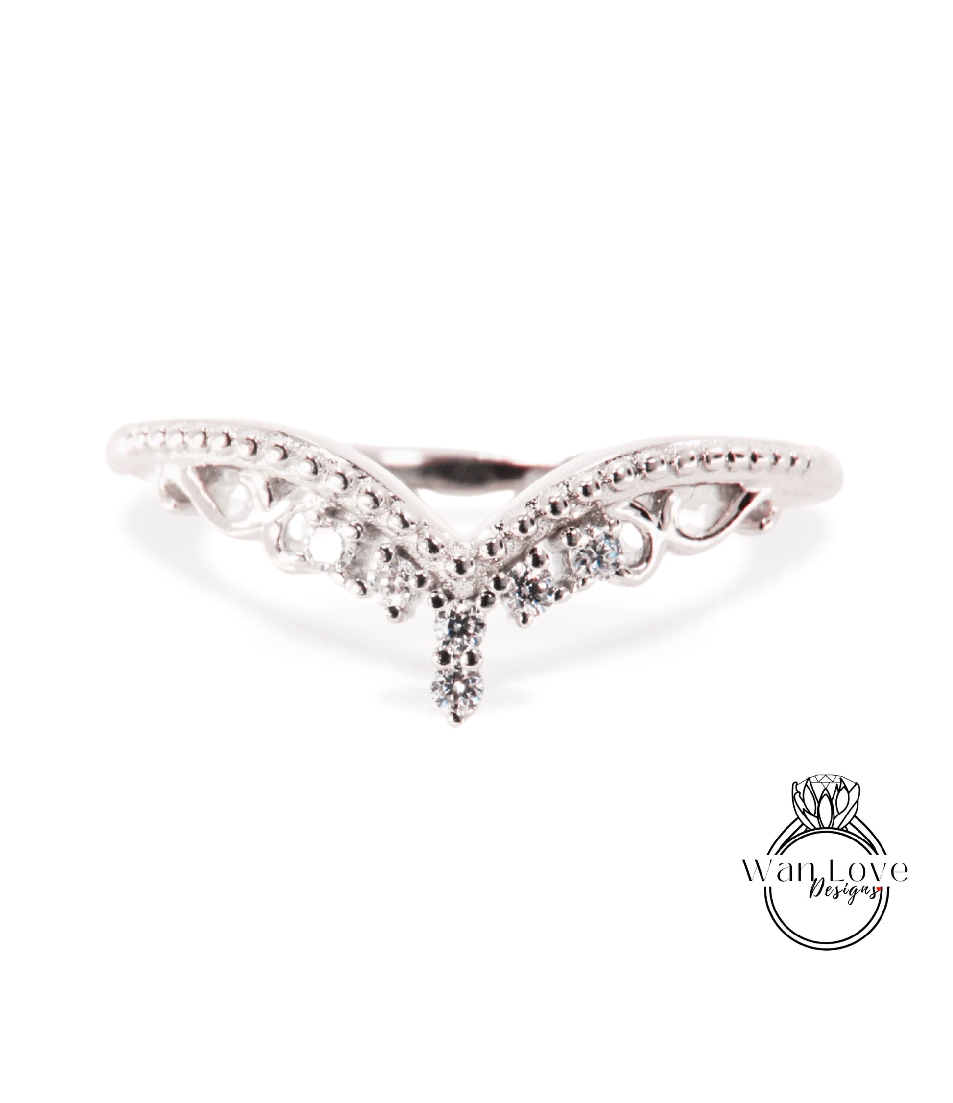A silver ring with a decorative design featuring a central diamond and smaller diamonds surrounding it.