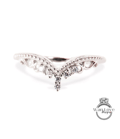 A silver ring with a decorative design featuring a central diamond and smaller diamonds surrounding it.