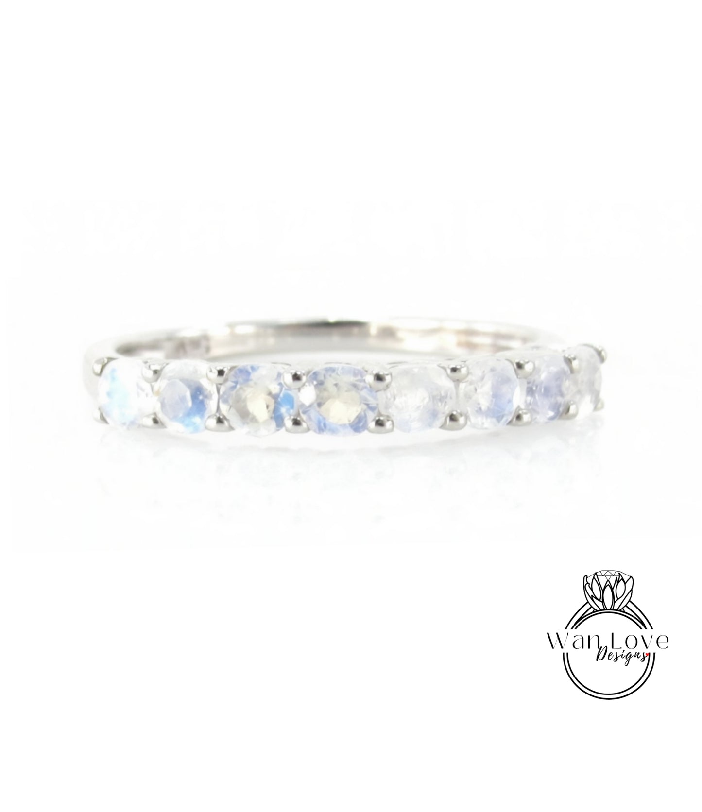 A silver ring with a row of blue moonstone stones set in a band.