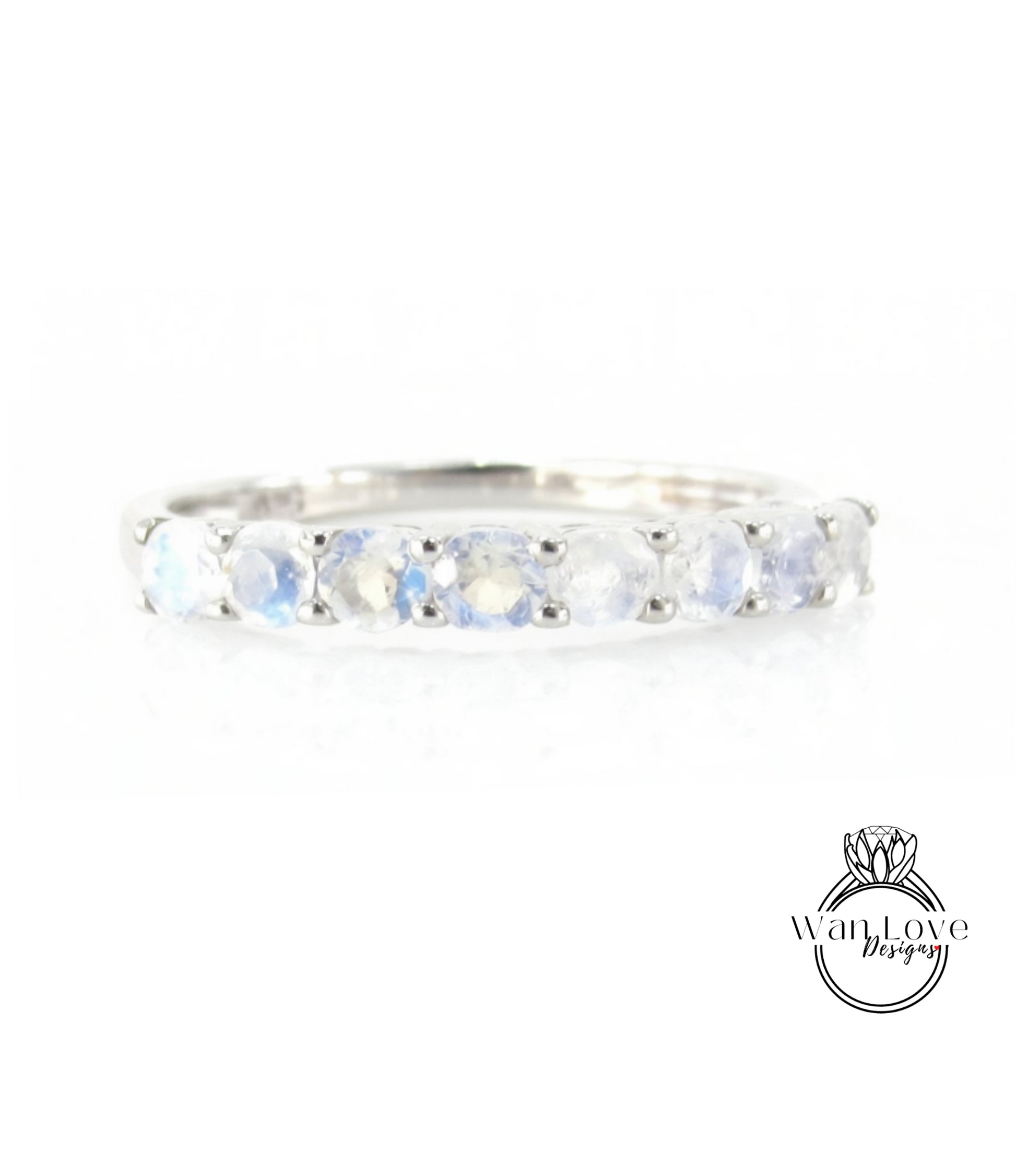 A silver ring with a row of blue moonstone stones set in a band.