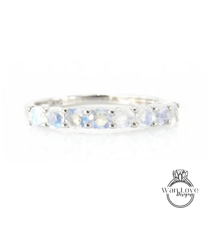 A silver ring with a row of blue moonstone stones set in a band.