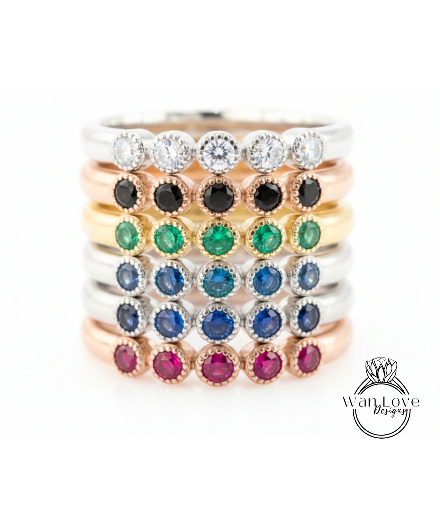 A stack of rings with various colored gemstones, including diamonds and gemstones, arranged in a visually appealing manner.