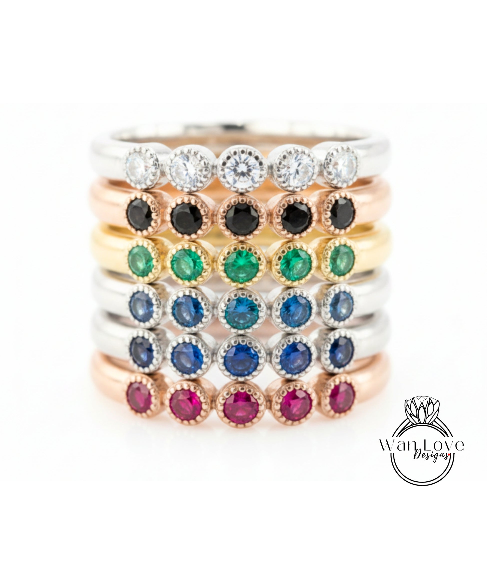 A stack of rings with various colored gemstones, including diamonds and gemstones, arranged in a visually appealing manner.