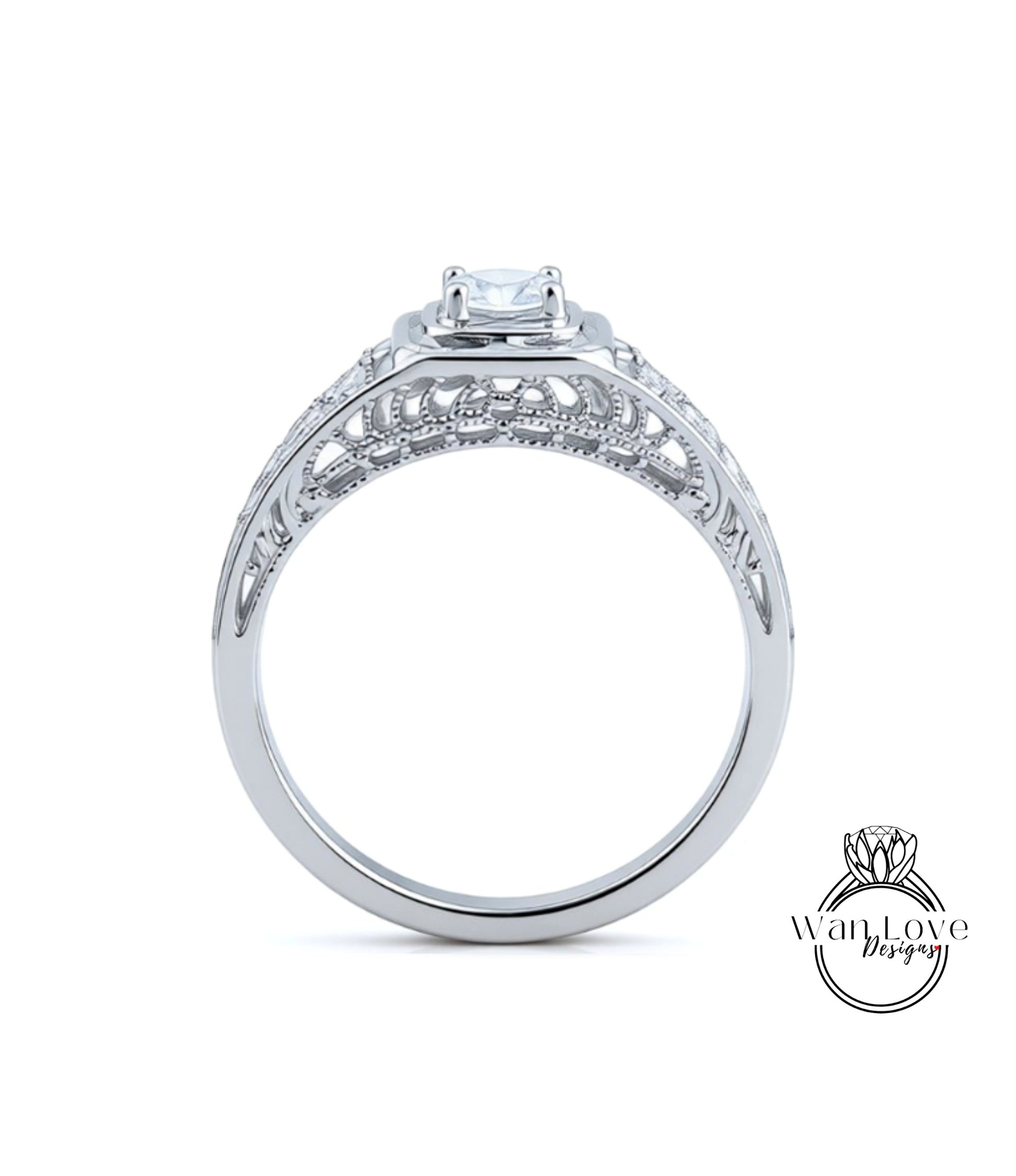 A close-up view of a silver engagement ring with a large central diamond and intricate metalwork detailing.