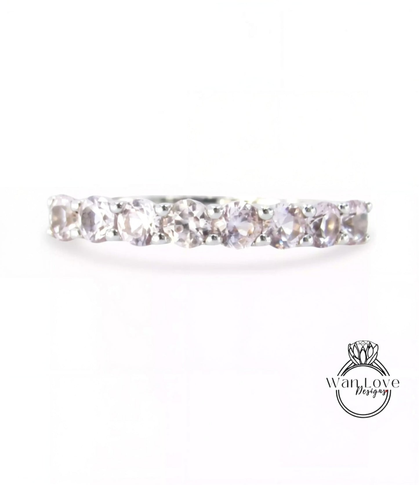 A silver ring with a row of clear gemstones, including diamonds, set in a band.