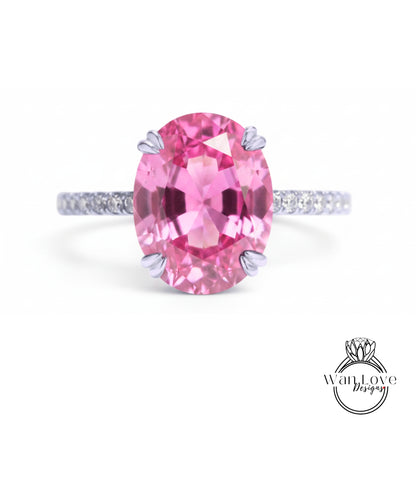 A pink gemstone ring with a large oval-shaped gemstone set in a silver band.