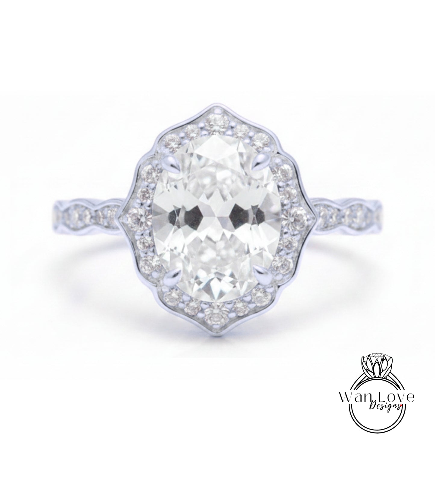 A close-up of a diamond engagement ring with a large oval-shaped diamond set in a halo of smaller diamonds.