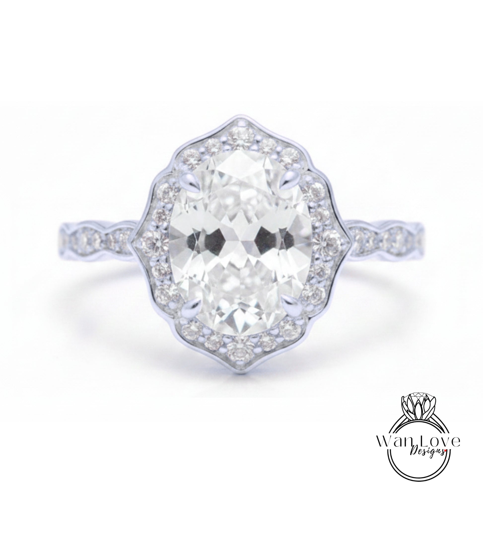 A close-up of a diamond engagement ring with a large oval-shaped diamond set in a halo of smaller diamonds.