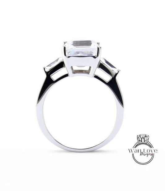A silver ring with a large, clear gemstone set in the center.