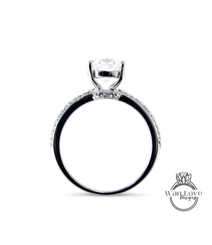 A silver engagement ring with a large central diamond and a halo of smaller diamonds around the band.