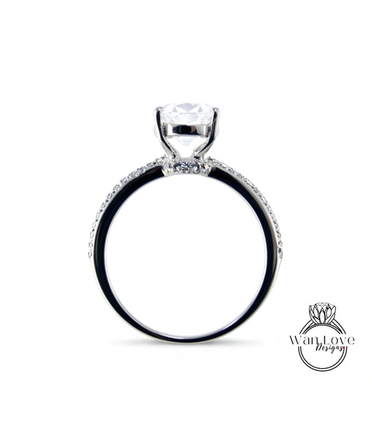 A silver engagement ring with a large central diamond and a halo of smaller diamonds around the band.
