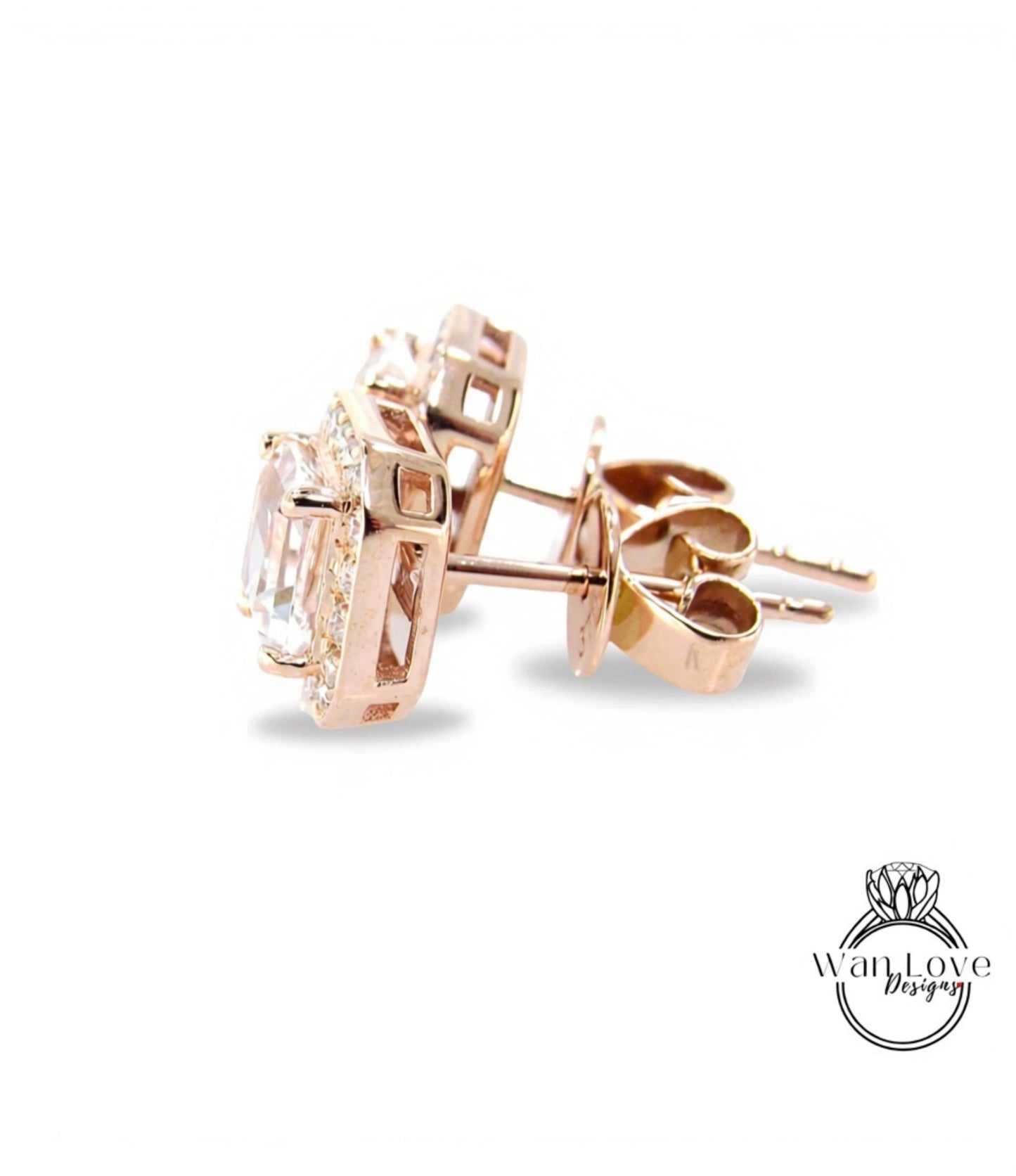 A pair of gold earrings with a clear gemstone set in the center, resting on a white background.