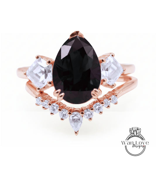 a beautiful rose gold ring with a large black gemstone at the center, surrounded by smaller clear gemstones.