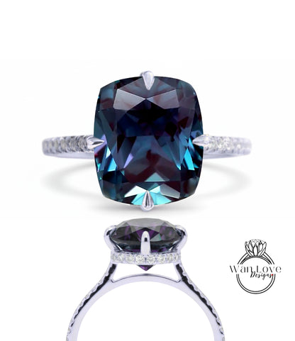 A large, blue gemstone ring with a silver band and a smaller gemstone on the bottom.