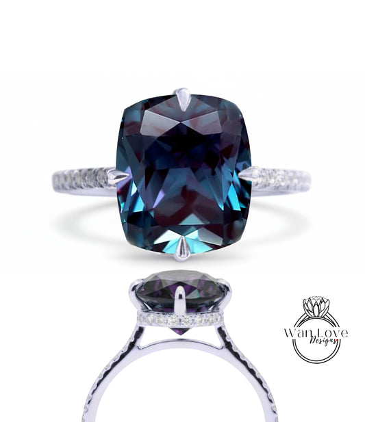 A large, blue gemstone ring with a silver band and a smaller gemstone on the bottom.