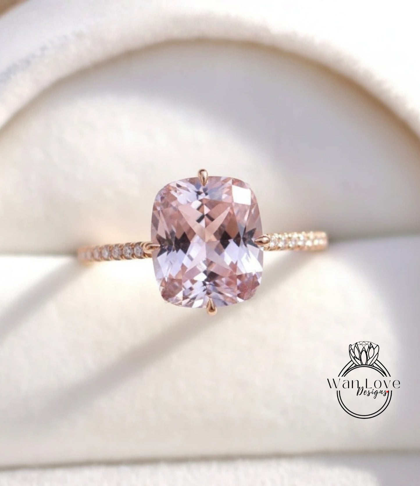 A close-up image of a gold ring with a large, pink gemstone set in the center.